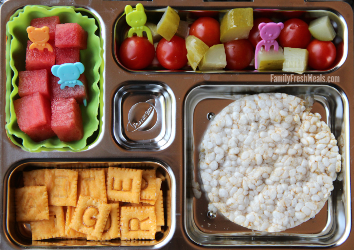 Rice cakes, , fresh fruit and veggies packed in a metal lunchbox