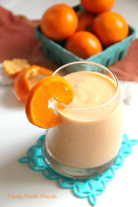 Sunburst Smoothie Recipe served in a small glass cup with an orange slice