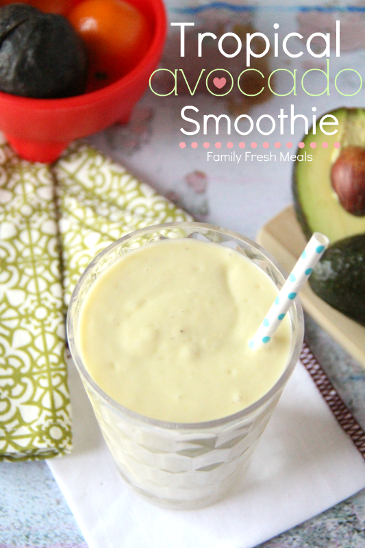 Tropical Avocado Smoothie in a glass with a straw