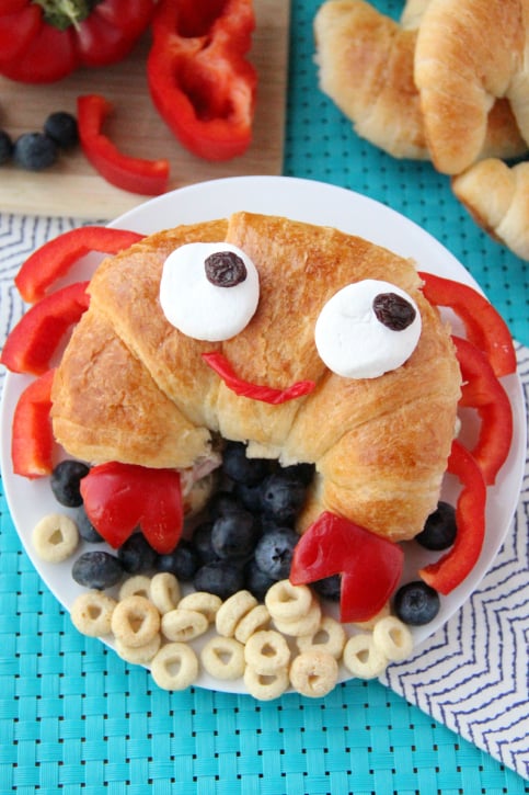 Croissant sandwich made to look like a crab - served on a white plate