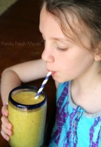 Child drinking Banana Mango Smoothie