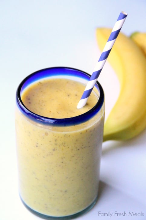 Banana Mango smoothie in a cup with a straw