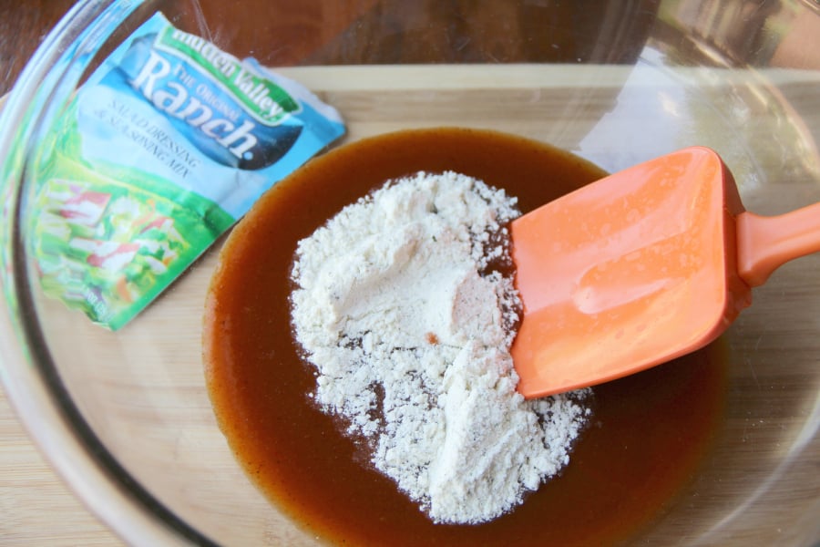 mixing together ranch powder and red sauce