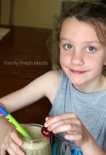 Child holding a Chocolate Cherry Smoothie