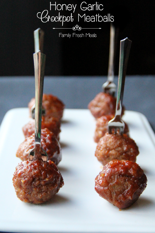 Honey Garlic Crockpot Meatballs on a white platter with mini forks