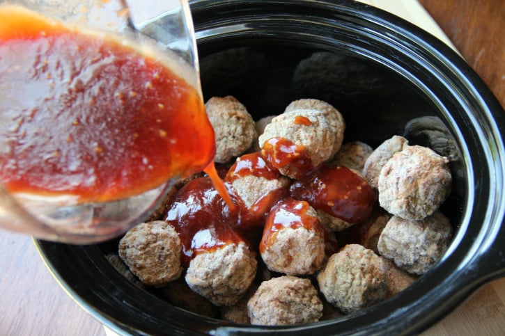 Pouring sauce over meatballs