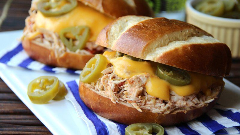 2 Slow-Cooker Jalapeno Popper Chicken Sandwiches on a white serving plate