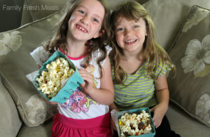 Two children holding bowls of popcorn
