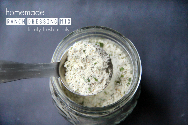 DIY Homemade Ranch Dressing Mix in a glass jar with a tablespoon scooping some out