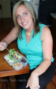 woman sitting with a salad in a lunchbox