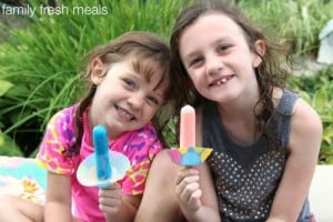 Two children holding popsicles 