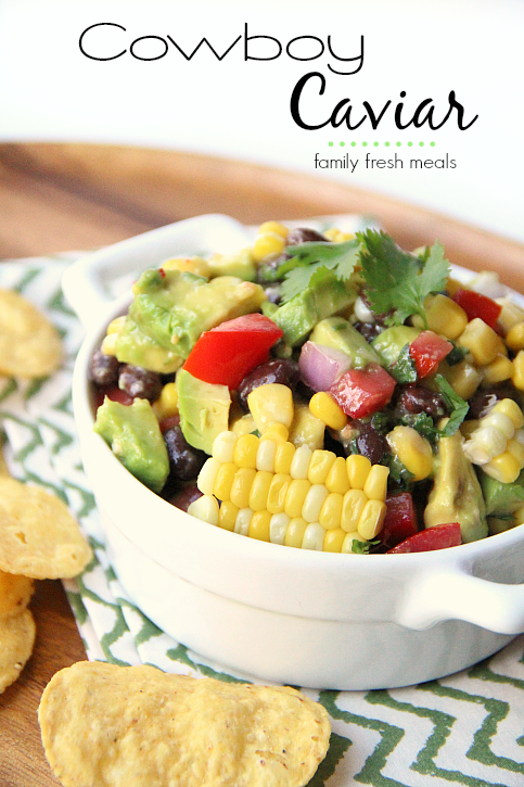 Cowboy Caviar in a white bowl surrounded by tortilla chips
