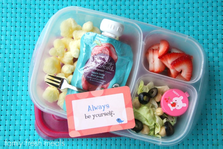 Corn puffs, an organic fruit puree squeeze pack, a small side salad and dressing and strawberries.  Packed in a Lunchbox