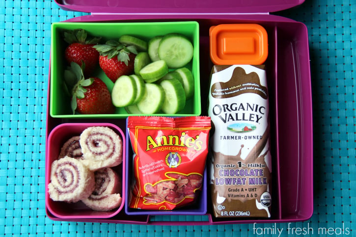 jelly sushi, strawberries, cucumbers, a container of dip, Annie’s Homegrown Fruit Snacks and an Organic Valley Milk.  Packed in a Lunchbox