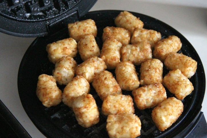 Tater Tots placed on a waffle iron