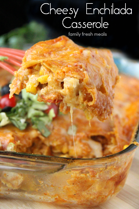 A pieced of Cheesy Chicken Enchilada Casserole being scooped out with a spatula 