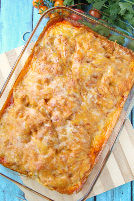 Cooked Cheesy Chicken Enchilada Casserole in a glass baking dish