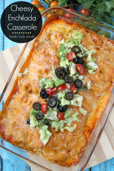 Cheesy Chicken Enchilada Casserole topped with shredded lettuce, sliced black olives and chopped tomatoes