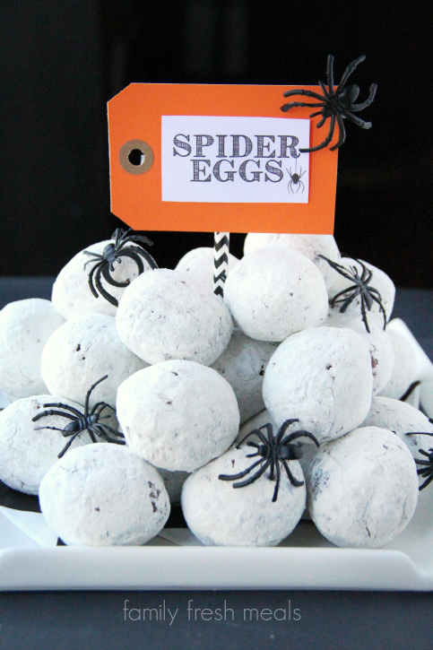  Donuts holes on a white plate with fake plastic spiders