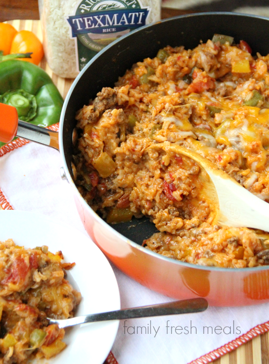 One Pot Stuffed Pepper Casserole in a pan with a wooden spoon scooping some out