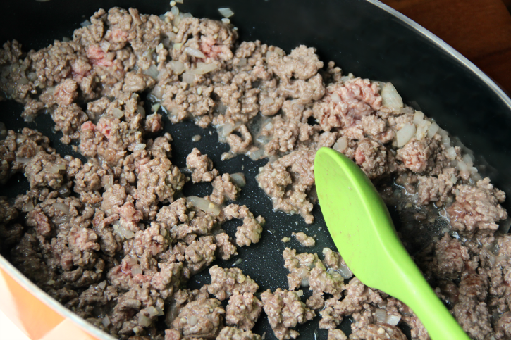 Ground beef cooking in a pan