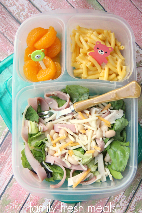 Chopped salad oranges and mac & cheese packed in a lunchbox