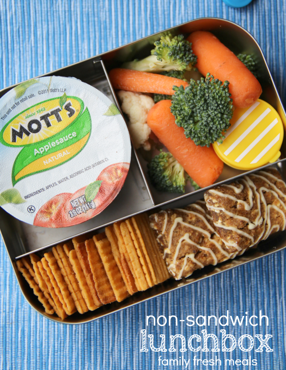 lunchbox packed with apple sauce, vegetables, crackers and a granola bar