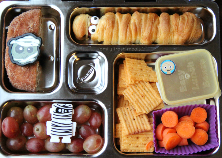 mummy hot dog, half of a baked pumpkin donut, grapes, crackers, carrots and a mini dipper of ketchup for dipping. Packed in a metal lunchbox