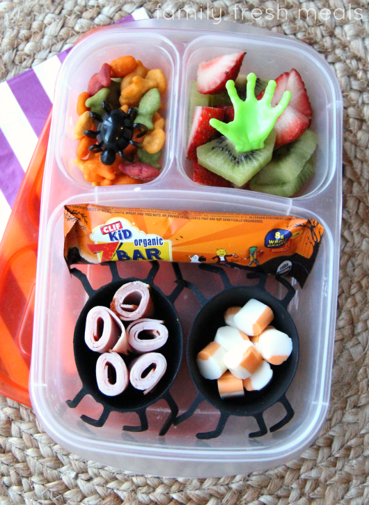 Lunch meat rolls, cheese bites, cheese crackers and some fresh fruit.  Packed in a plastic lunchbox