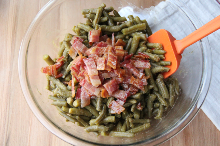 adding chopped bacon to green beans