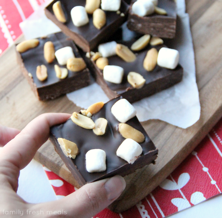 Hand picking up a piece of Easy Rocky Road Fudge