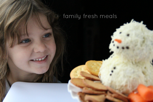 Child smiling at holiday themed cheese ball