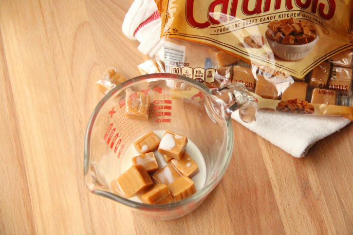 caramels and some milk in a glass measuring cup