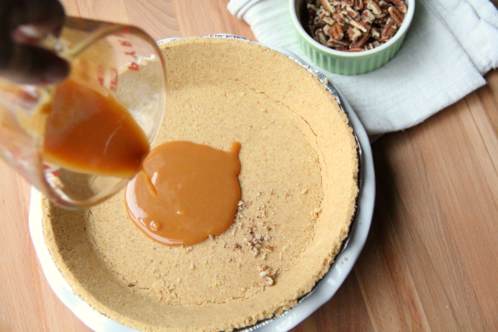 Pouring caramel into pie crust