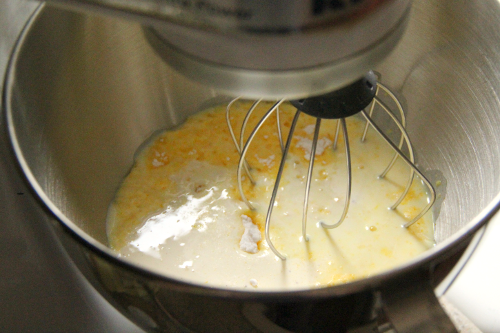 Mixing together pudding mixes, eggnog and milk in a stand mixer