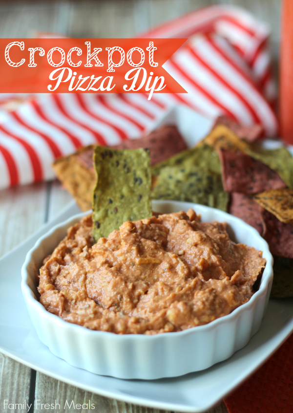  Crockpot Pizza Dip in a white bowl with tortilla chips