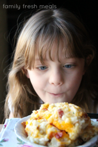 Child looking a a big serving of potato casserole