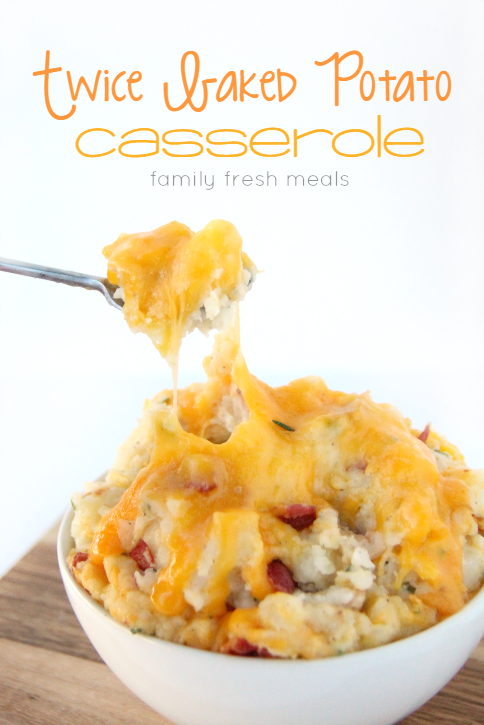 Easy Twice Baked Potato Casserole in a white bowl with a spoon scooping up some