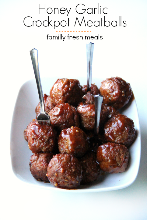  Honey Garlic Crockpot Meatballs in a white bowl with mini forks