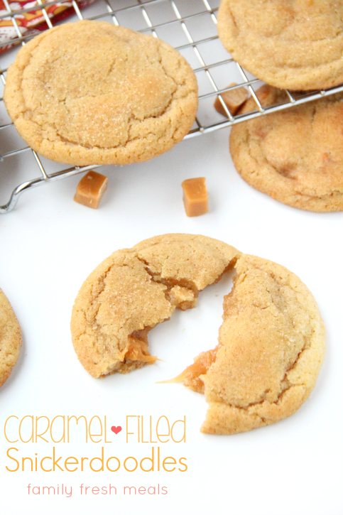 Soft and Chewy Caramel Filled Snickerdoodle Cookies on a cooling rack and one cooke split open