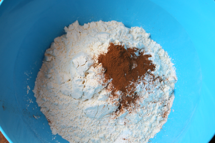 dry ingredients being mixed in a blue bowl