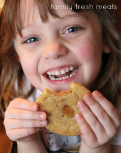 Child holding a cookie smiling