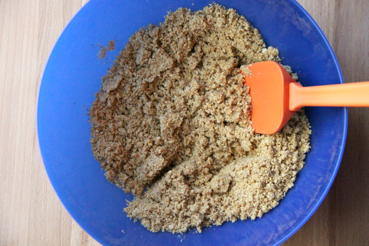 Stirring crust mixture in a blue bowl