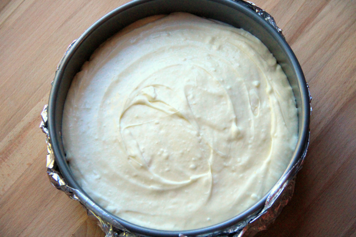 Cheese cake mixture being added to pan