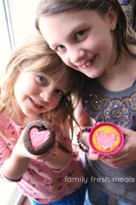 Two children holding Heart Valentine Cupcakes 