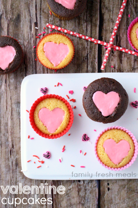 Easy Heart Valentine Cupcakes on a table and on a white platter. 