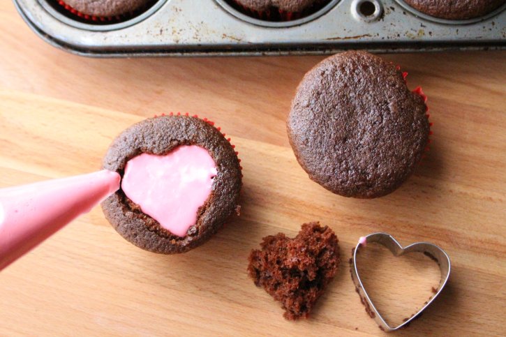 filling heart cut out with pink frosting