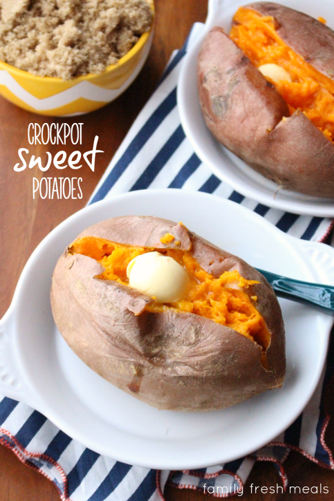 Sweet potatoes on white plates, with a bowl of brown sugar