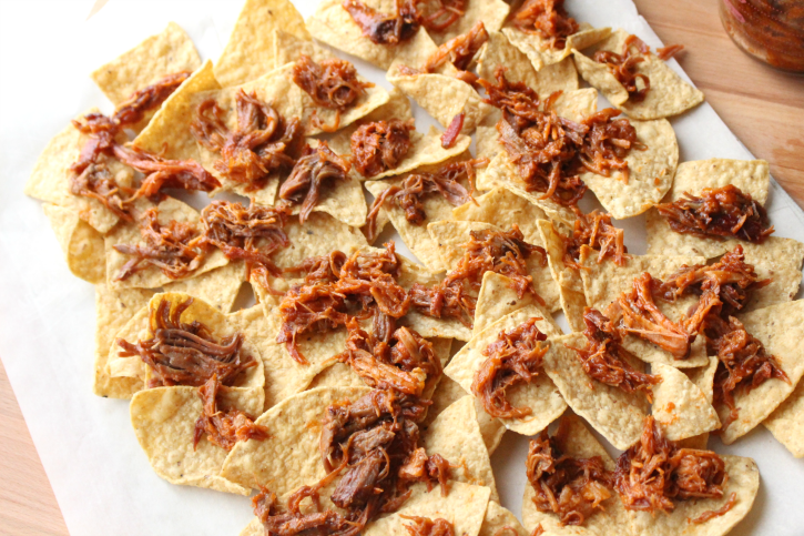 Pulled Pork Nachos placed on top of tortilla chips