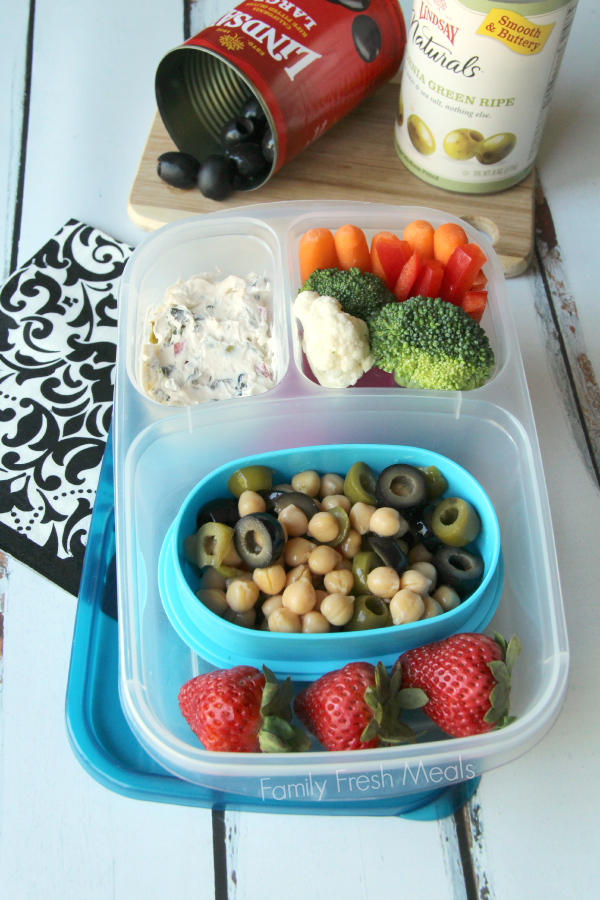 Chickpea salad and olive spread, chickpea and olive salad, veggies and strawberries packed in a lunch box